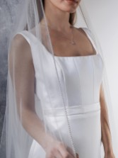 Photograph: Rainbow Club Flame Ivory Diamante Edge Chapel Length Veil